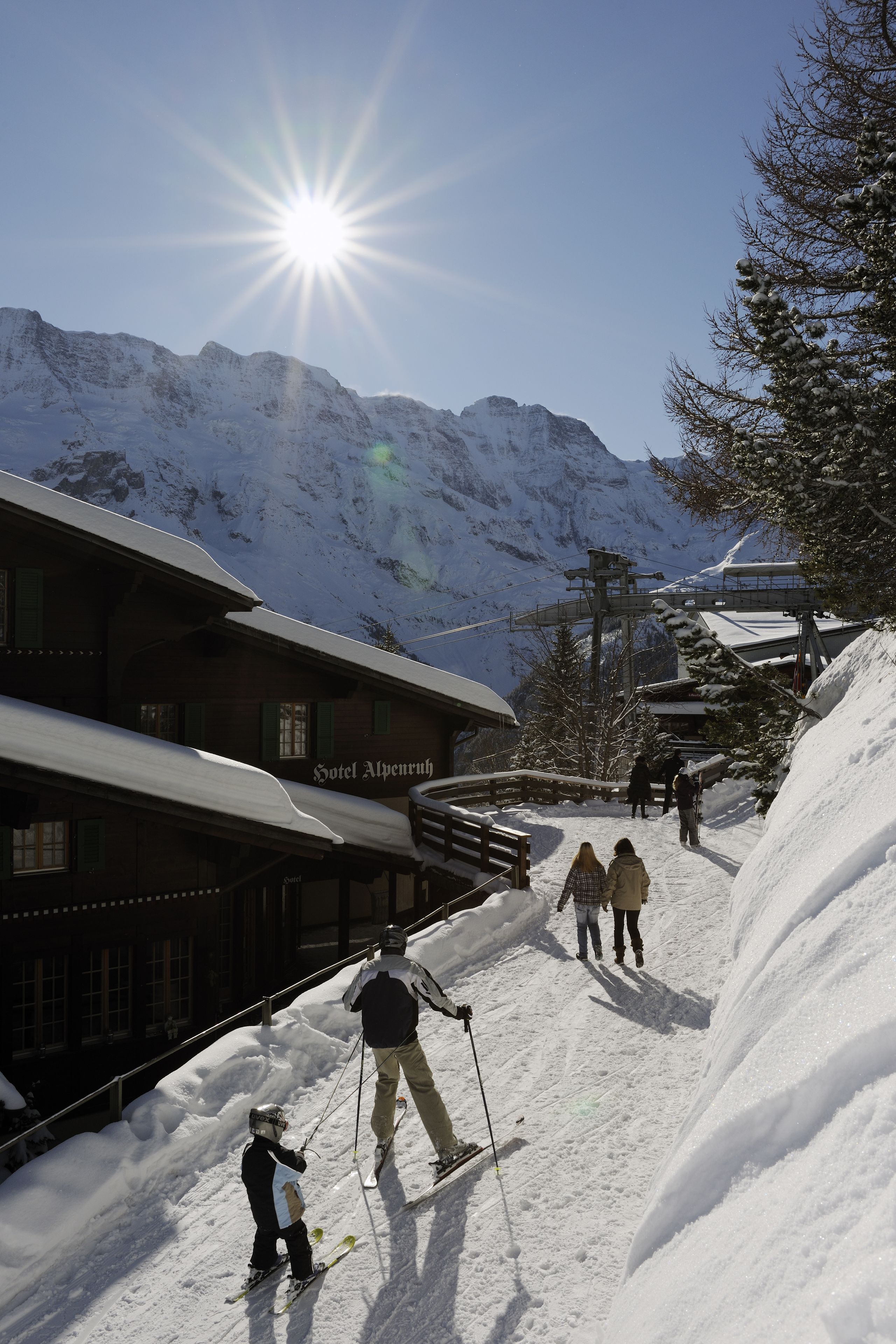 A ski resort with a wooden building labeled "Hotel Alpensuh."