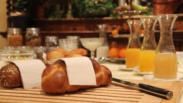 A wooden cutting board with bread and a knife.