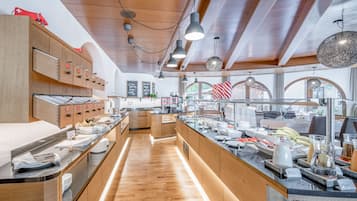 Un bufé de desayuno moderno con muebles de madera, una isla central y una variedad de alimentos.