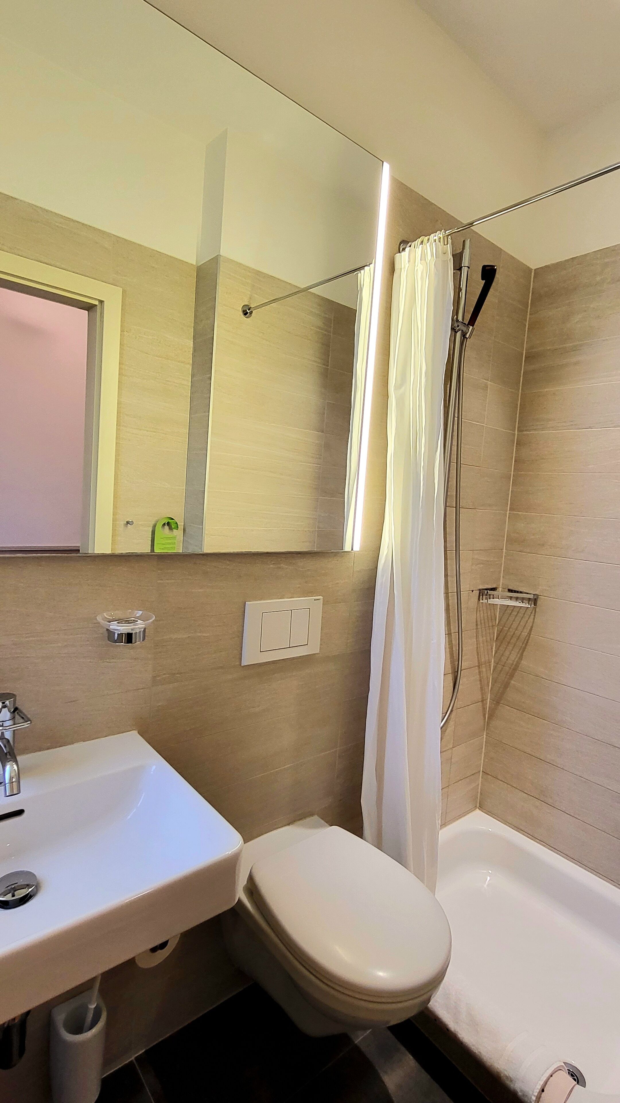 A bathroom with a sink, toilet, and shower.