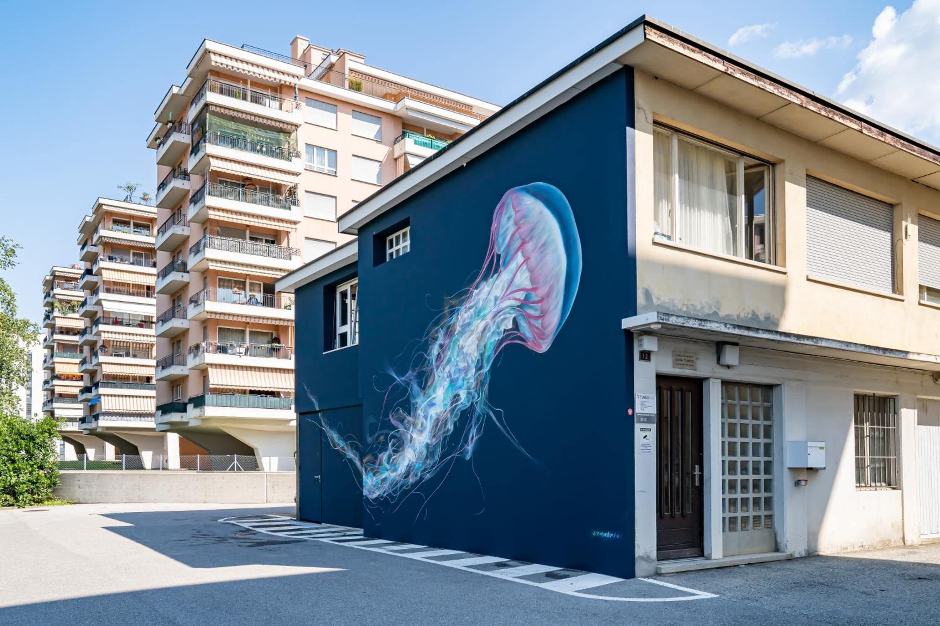 A building with a large mural of a jellyfish on its side.