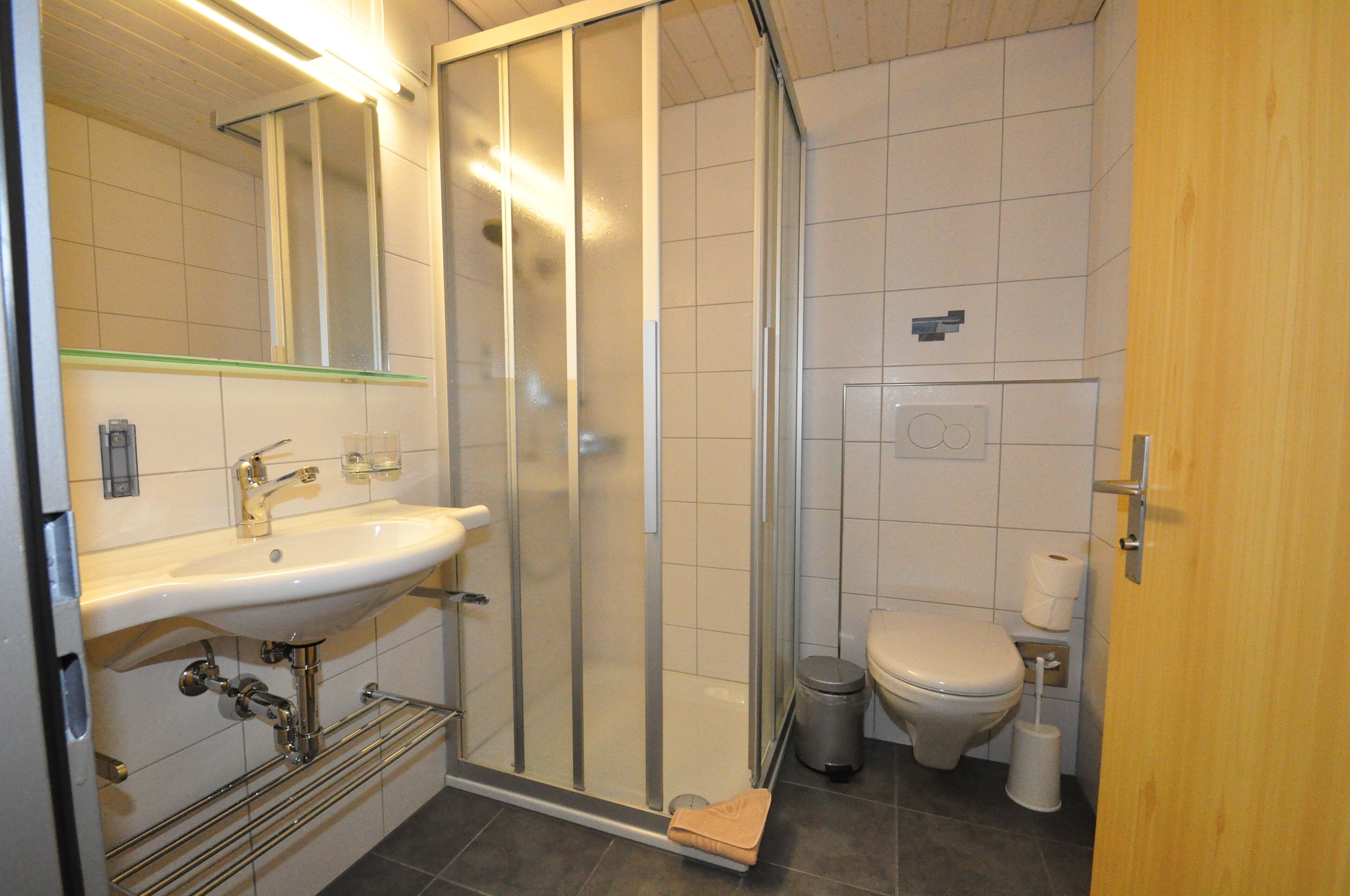 deep-soaking bathtub, rainfall showerhead, hair dryer, towels