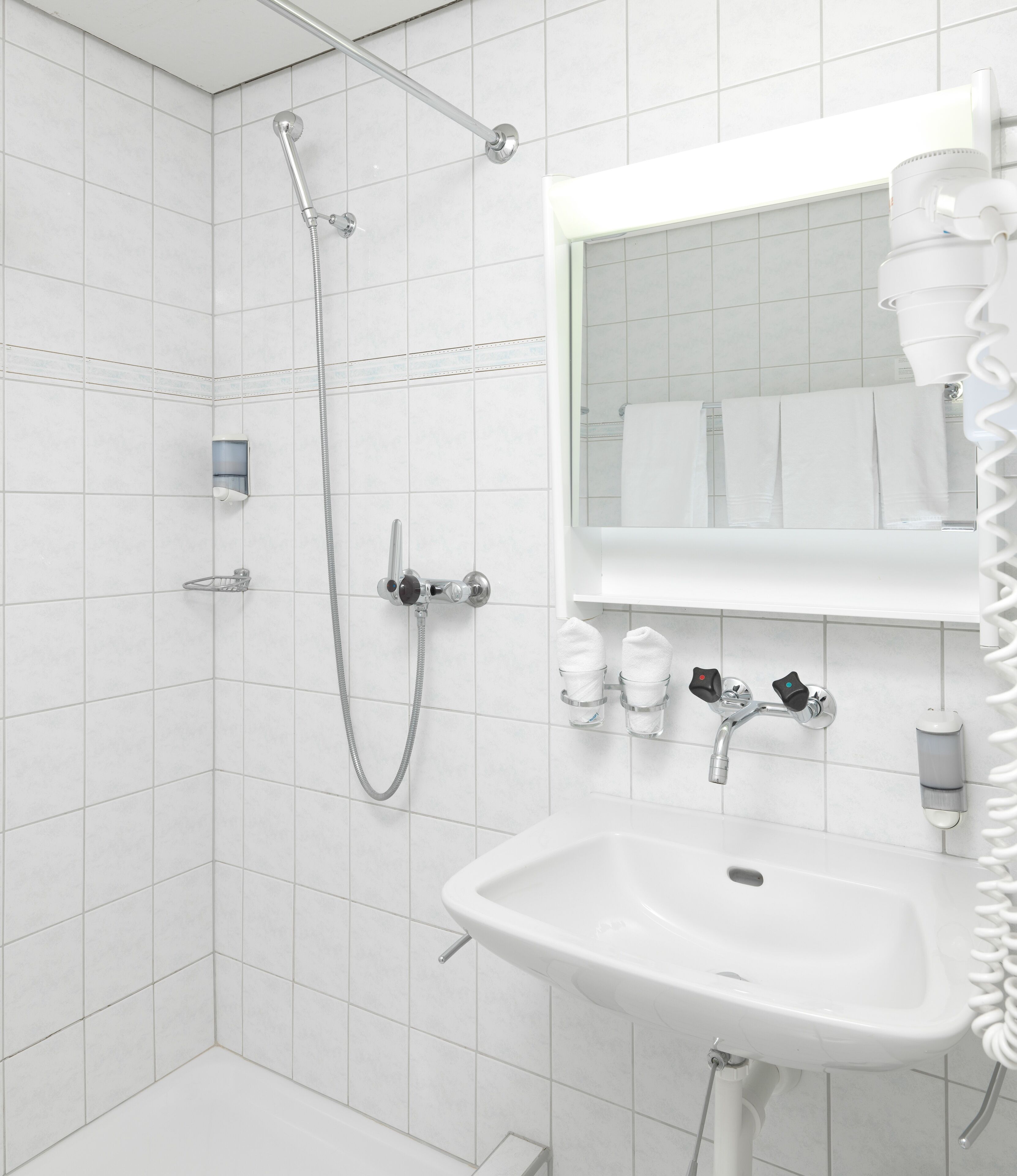 shower, hair dryer, slippers, towels