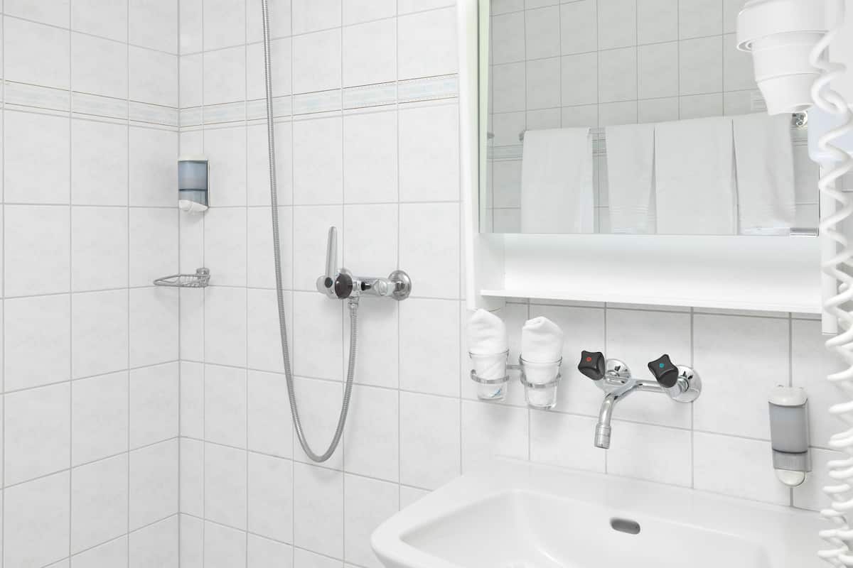 shower, hair dryer, slippers, towels