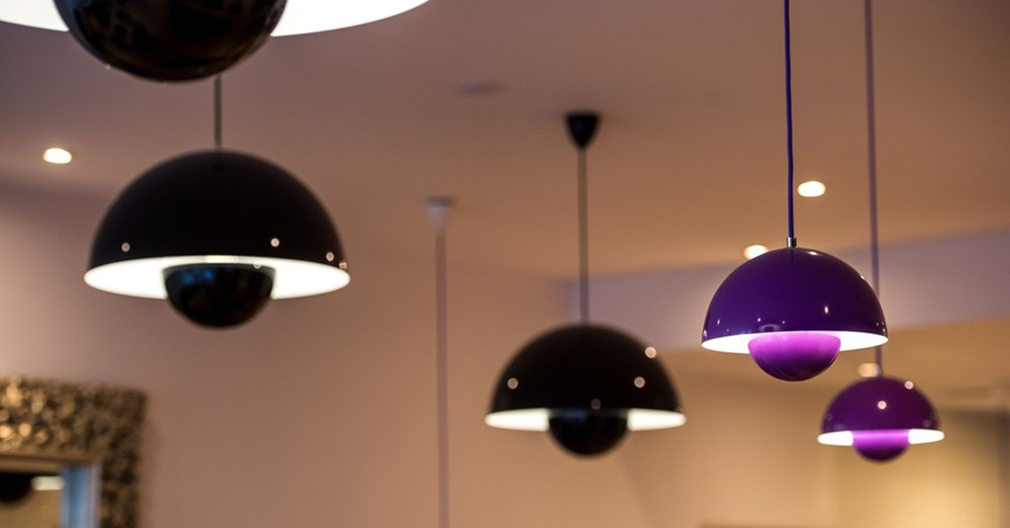A ceiling with multiple spherical pendant lights.