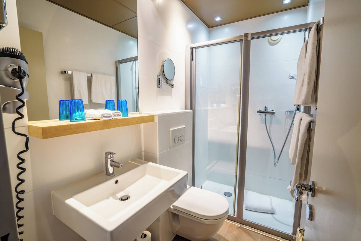 designer toiletries, hair dryer, towels