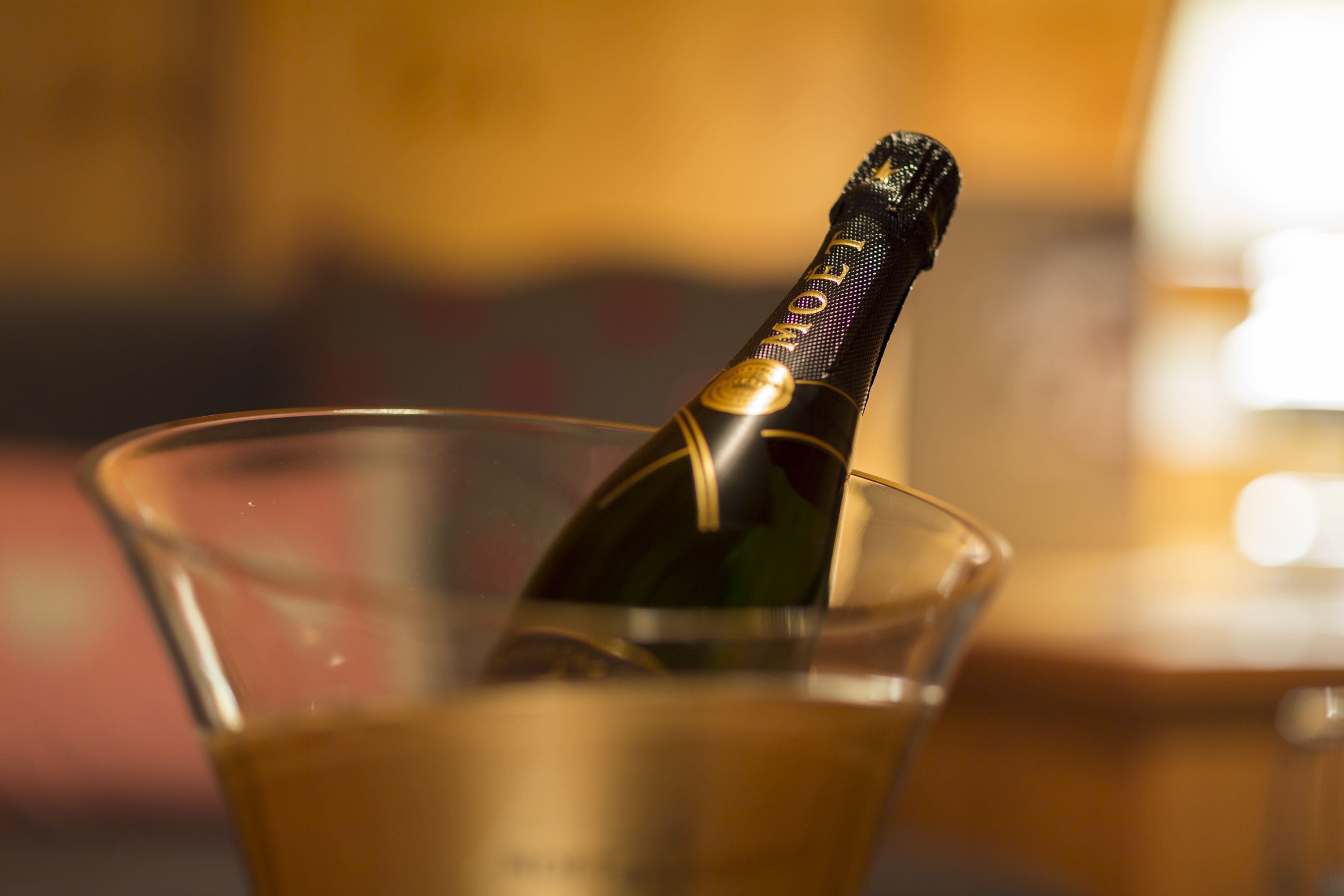 A bottle of champagne in a glass.