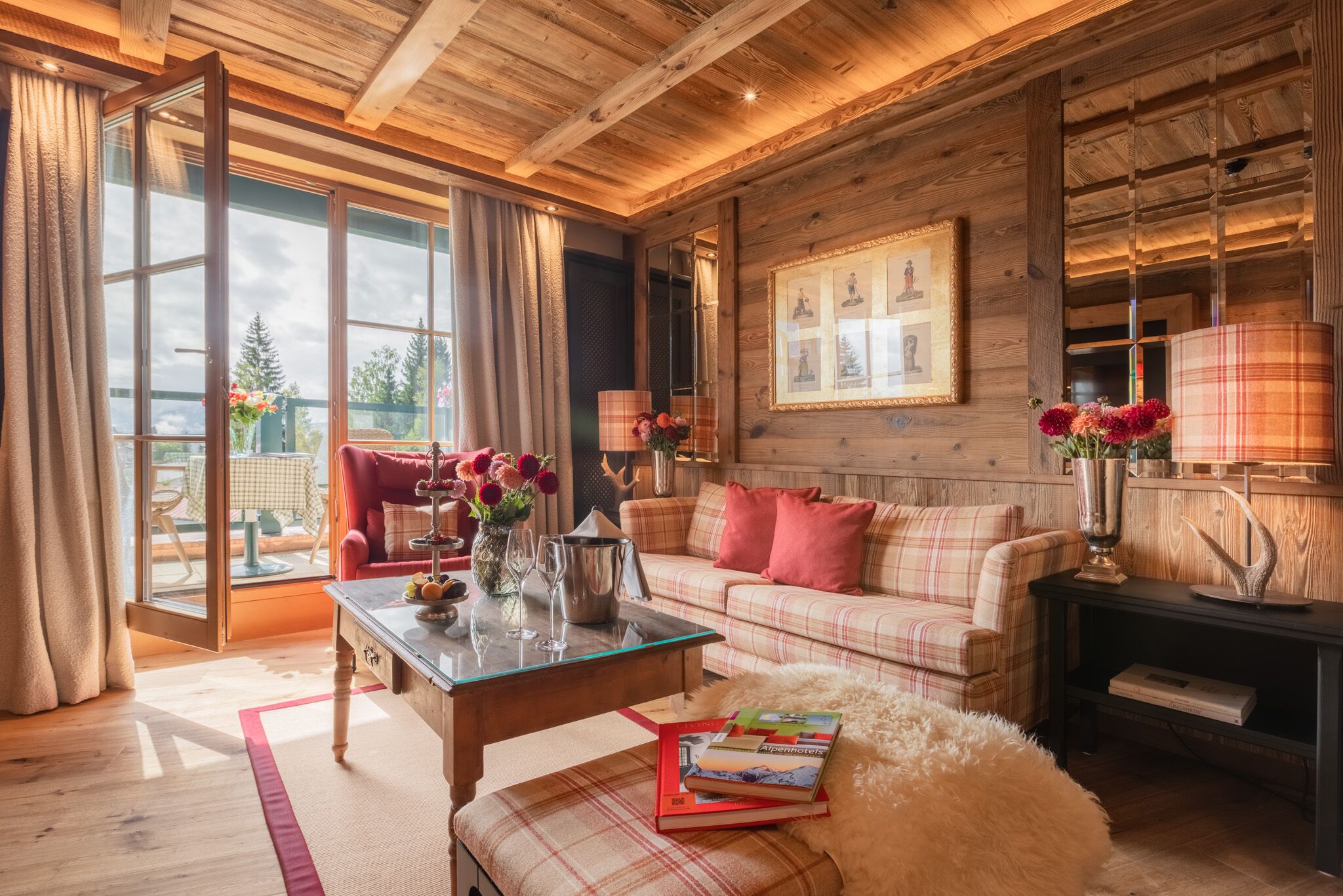 A cozy living room with a plaid sofa, a glass coffee table, and a fireplace.