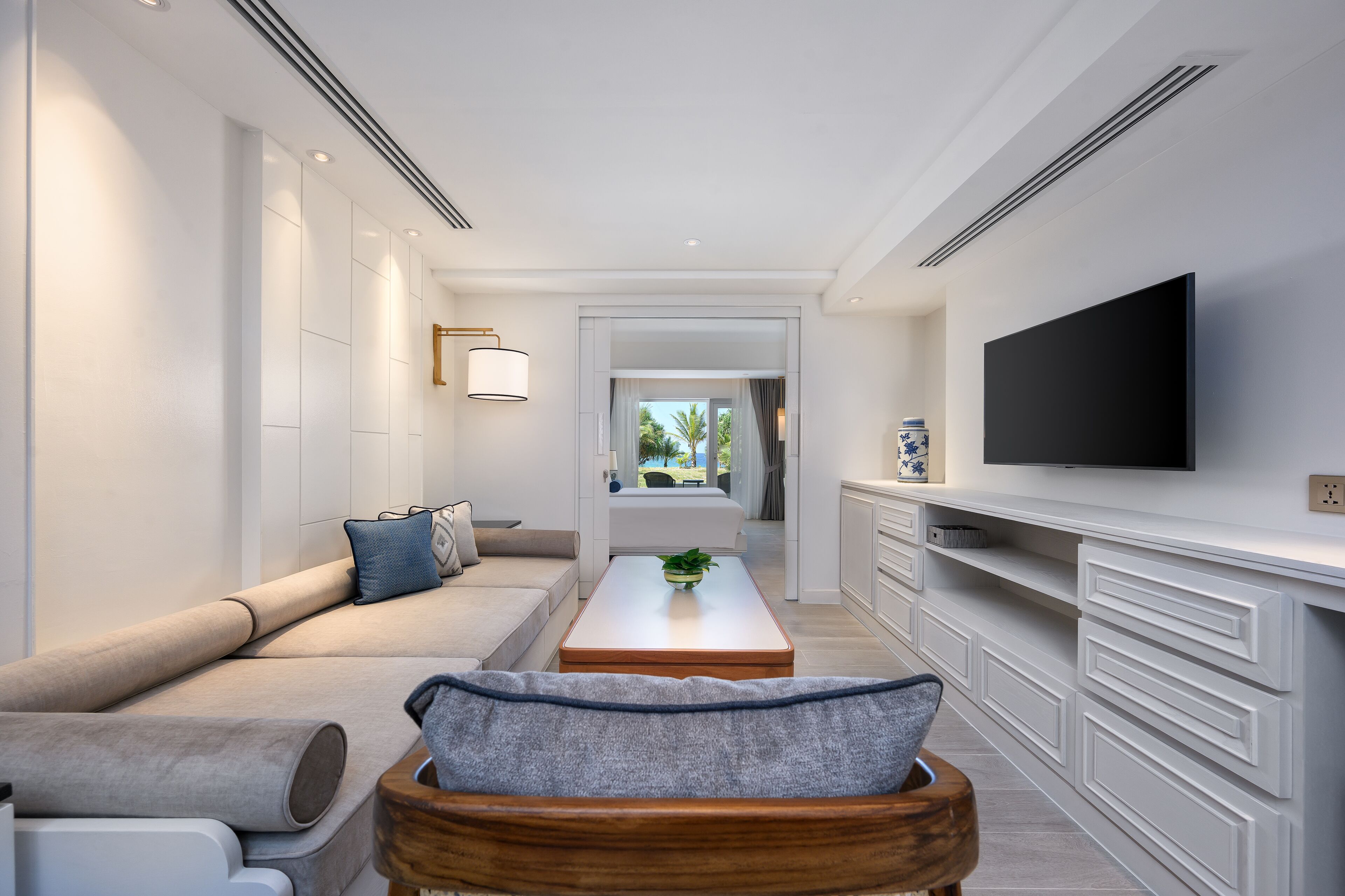 A modern living room with a sofa, coffee table, and TV.