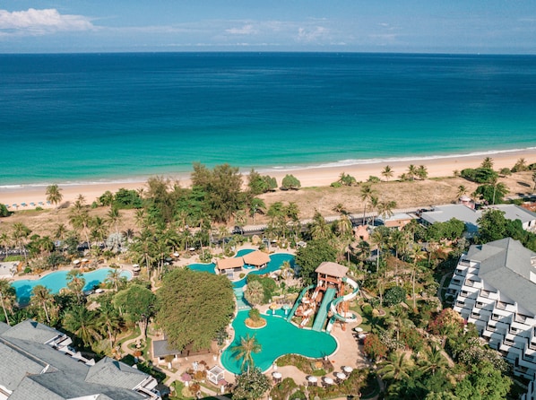 A resort with multiple swimming pools, a water slide, and a beach view. - Thavorn Palm Beach Resort Phuket (Karon)