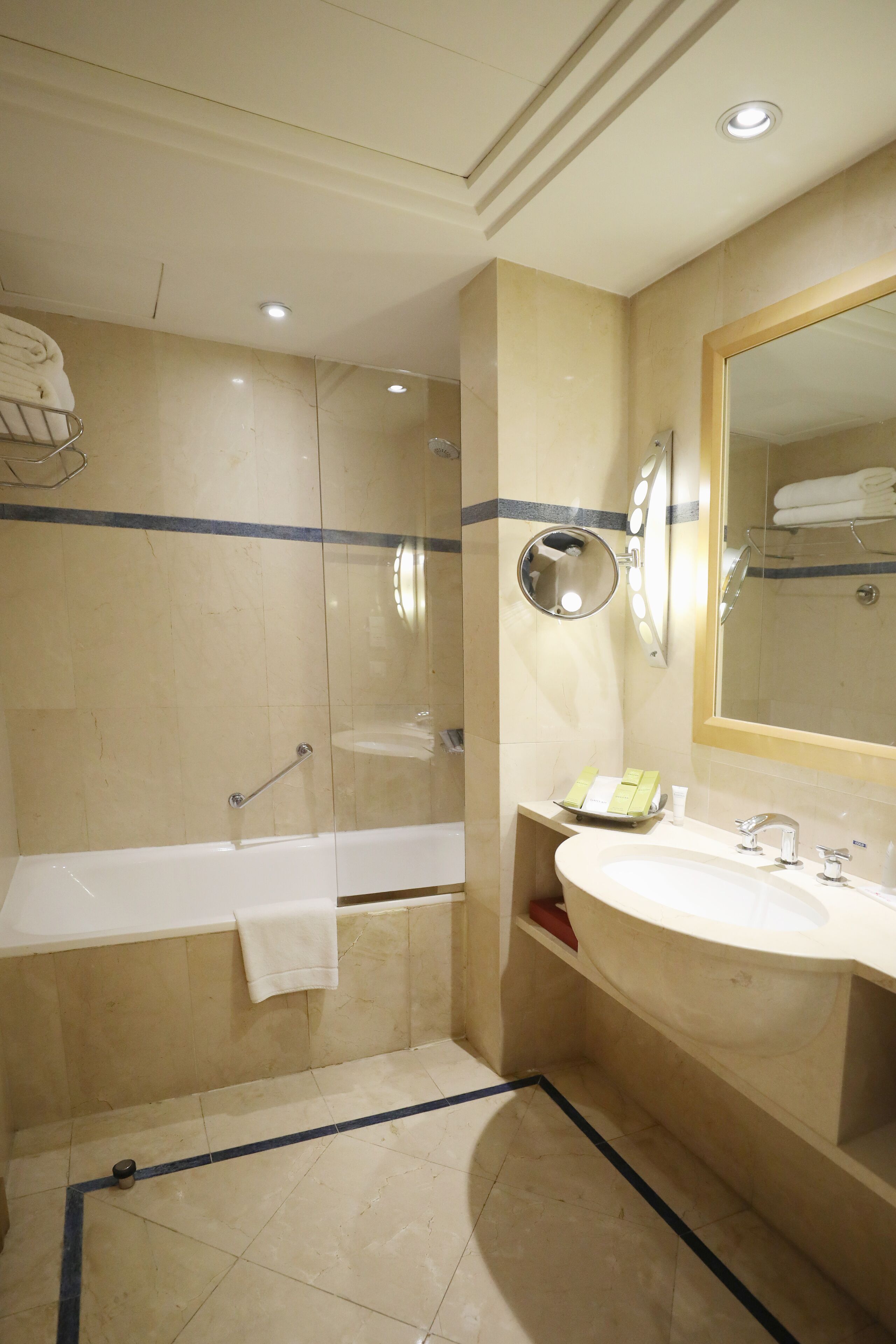 A bathroom with a bathtub, a sink, and a mirror.