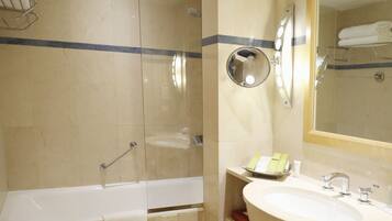 A bathroom with a bathtub, a sink, and a mirror.