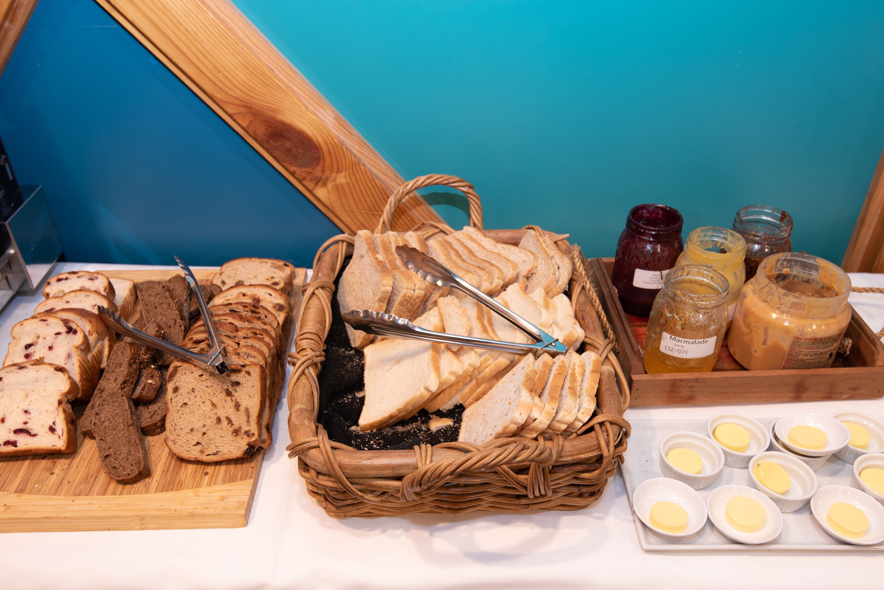A variety of breads and jams on a table.