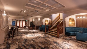 A spacious lobby with a grand staircase, seating areas, and a patterned carpet. - The Roker Hotel, BW Premier Collection (Sunderland)