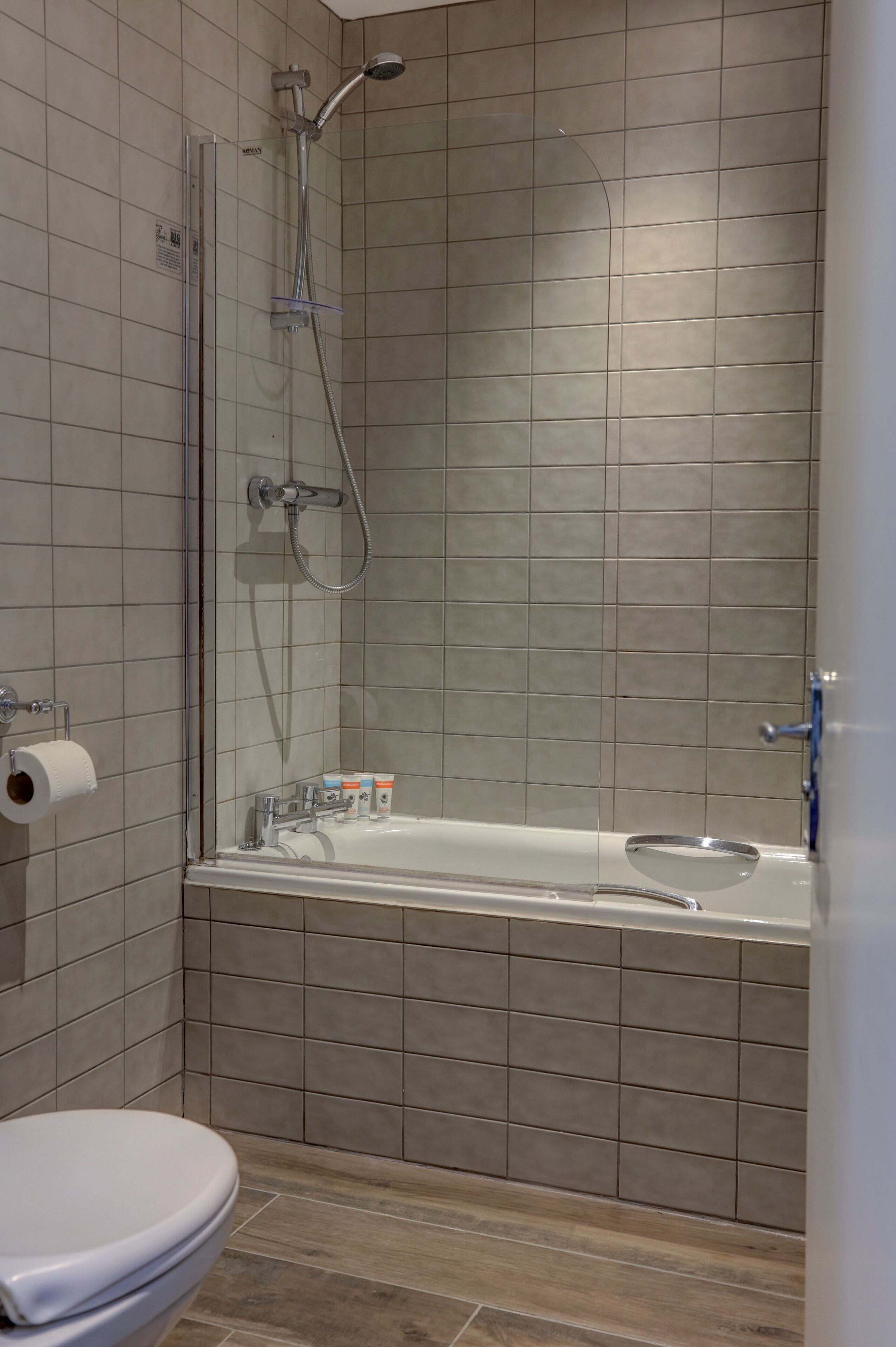 Un baño con ducha, inodoro y bañera.