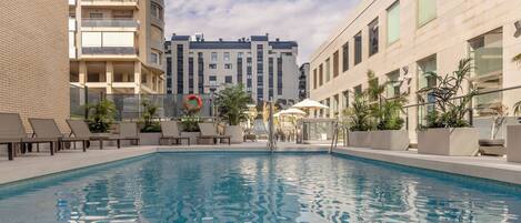 Seasonal outdoor pool, open 11:30 AM to 6:00 PM, pool loungers