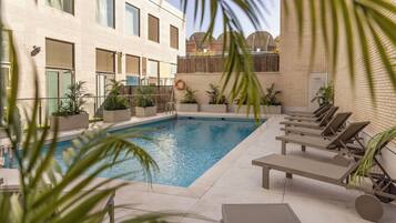 Seasonal outdoor pool, open 11:30 AM to 6:00 PM, pool loungers