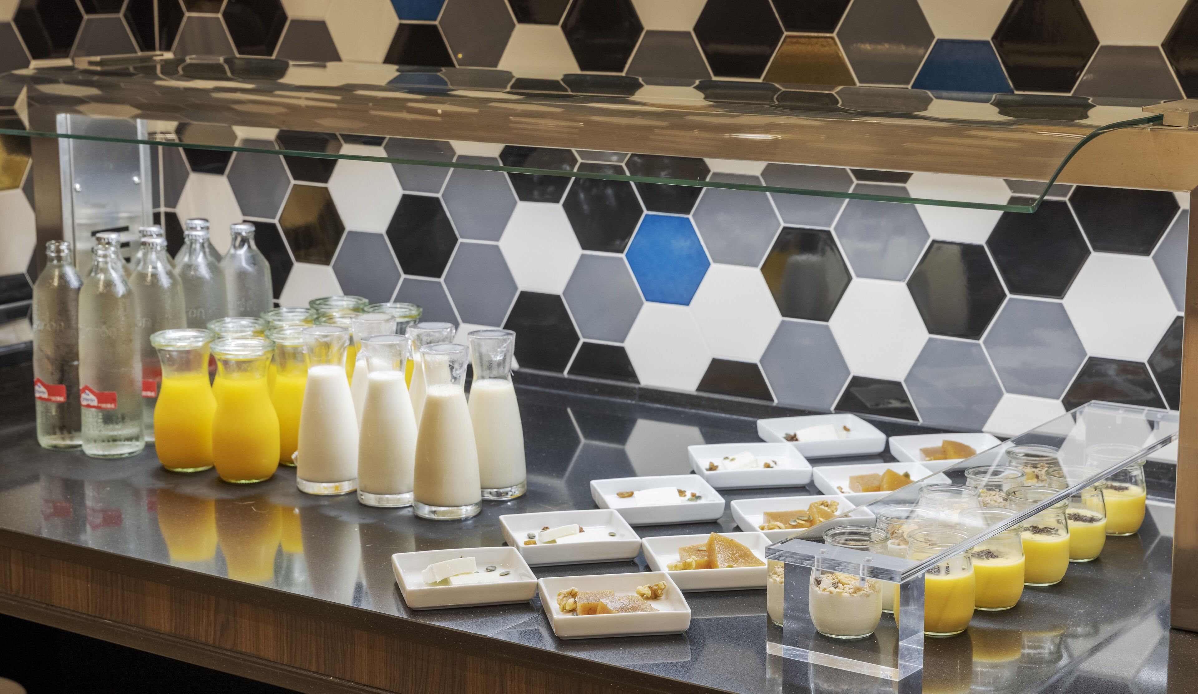 A breakfast buffet with various food items and beverages.