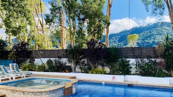 Alberca al aire libre y camastros