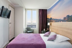 A hotel room with a bed, a TV mounted on the wall, a chair, a window with a view of a cityscape, and a curtain. - Best Western Rives de Paris La Defense (Courbevoie)