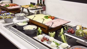 Ein Buffet mit einer Auswahl an Käse, Fleisch und Obst.