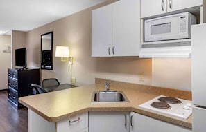 Full-sized fridge, microwave, cookware/dishes/utensils