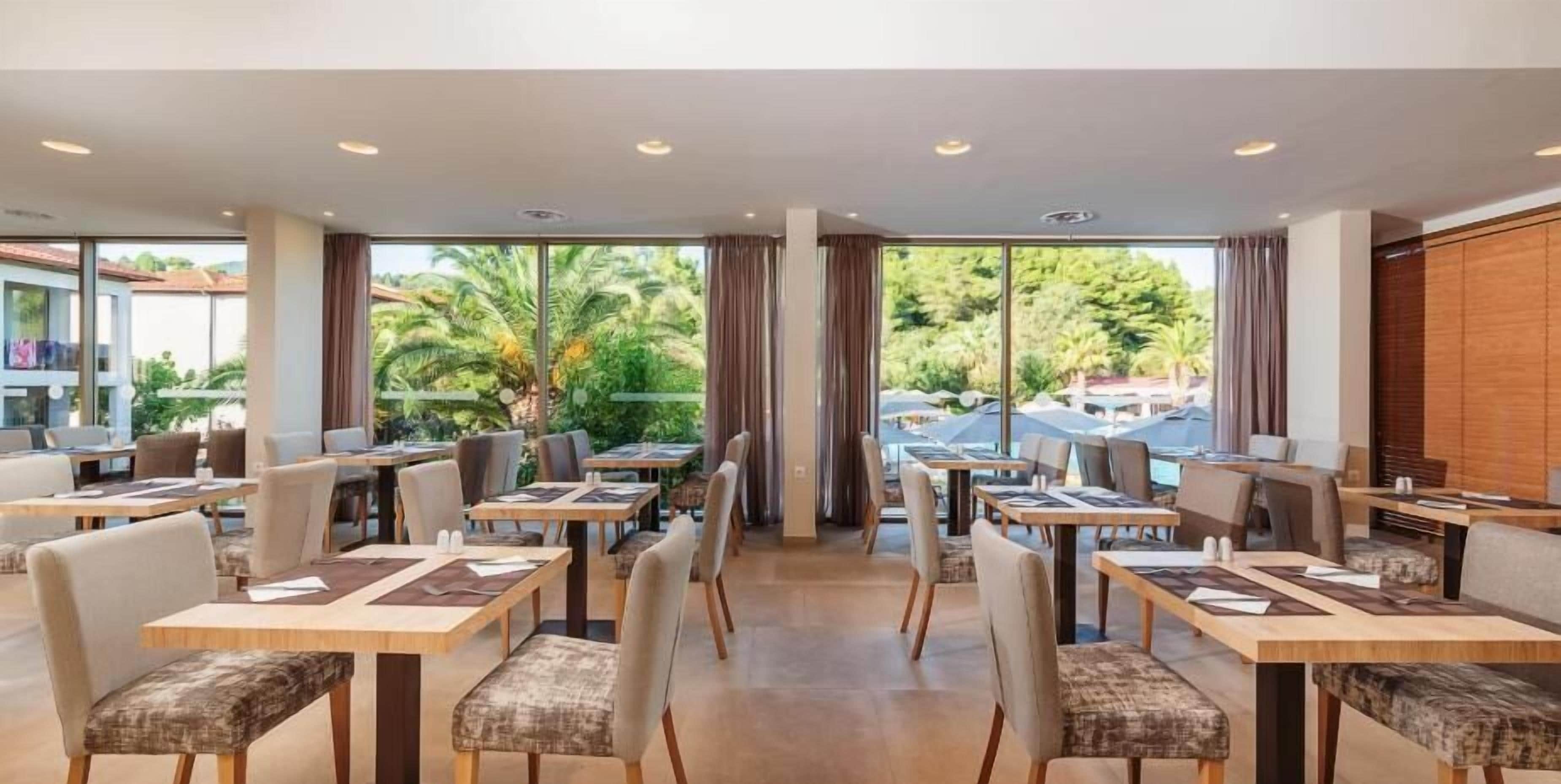 A restaurant with tables and chairs arranged for dining.