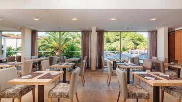 A restaurant with tables and chairs arranged for dining.