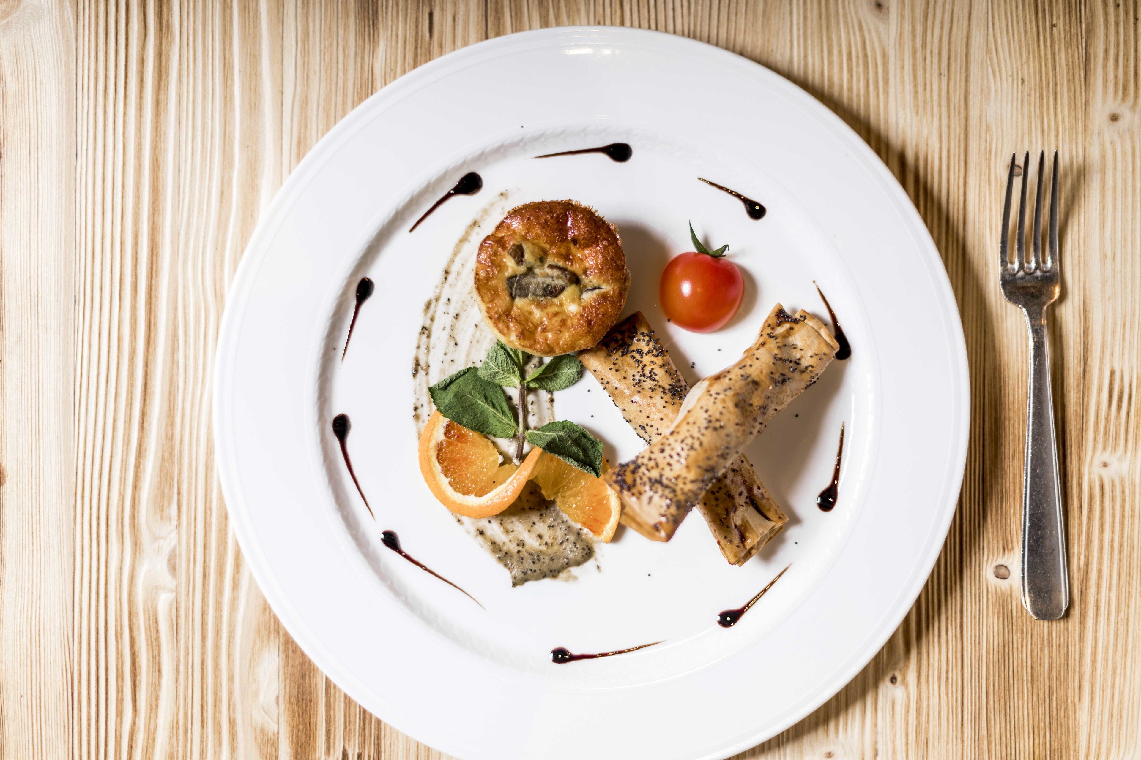 A plate with food on a wooden table.