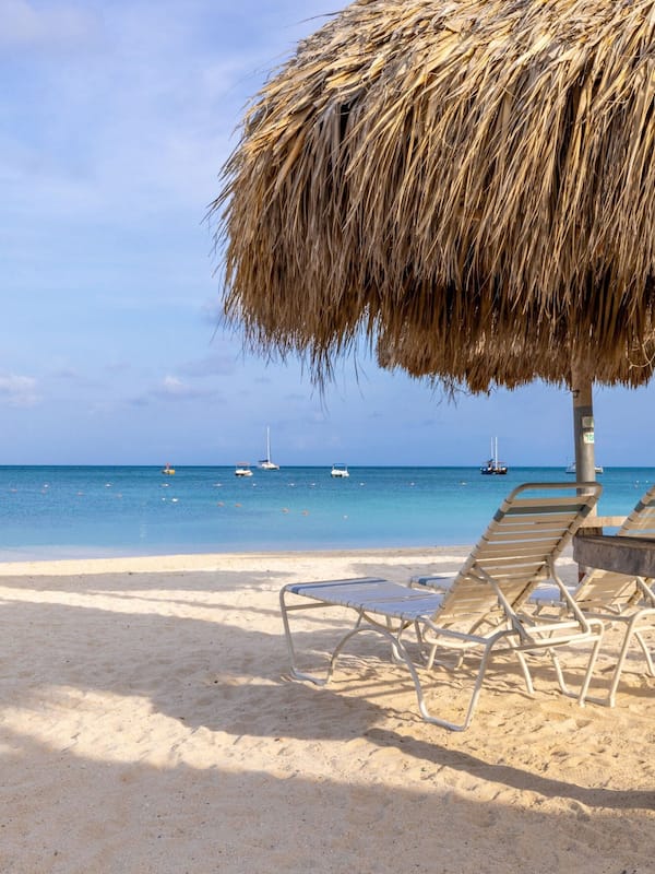 On the beach, white sand, beach cabanas, sun loungers
