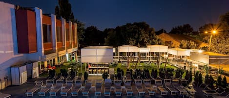 Una piscina cubierta, una piscina al aire libre de temporada, sombrillas