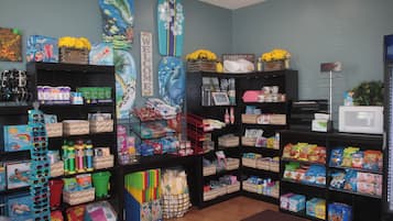 A store with shelves stocked with various products including snacks, beverages, and household items.