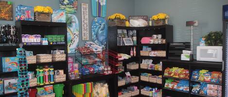 A store with shelves stocked with various products including snacks, beverages, and household items.