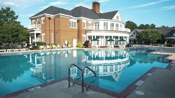 Relax by the inviting pool surrounded by comfortable lounge chairs and umbrellas.
