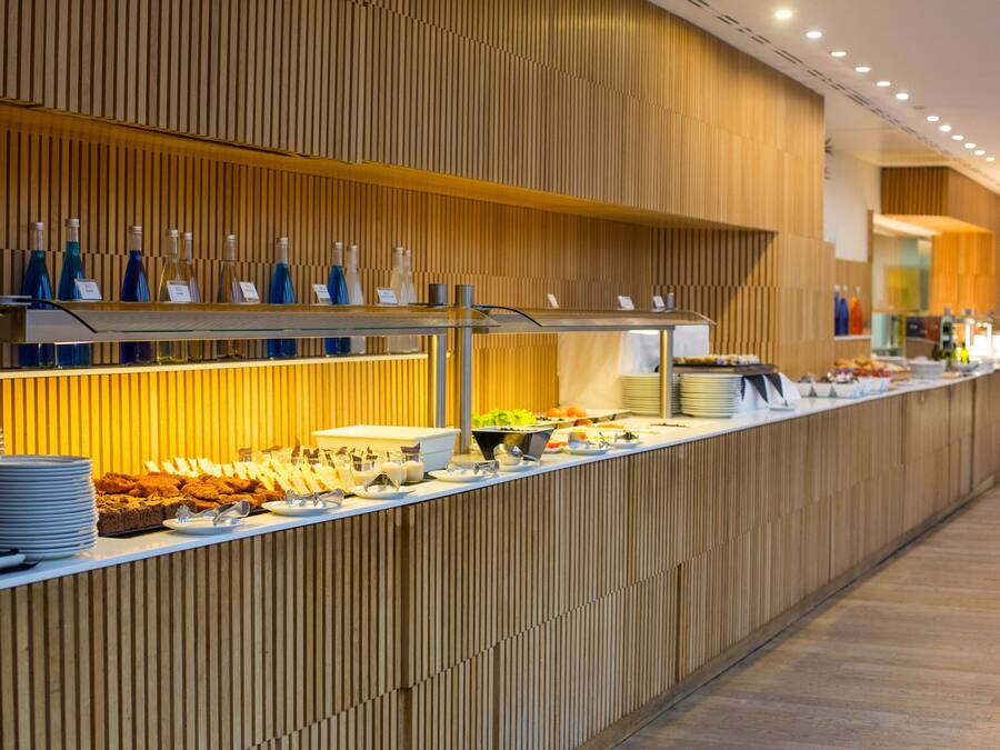 A buffet area with various food items and beverages.