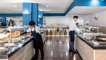 A buffet setup with multiple food stations and a blue and white color scheme.