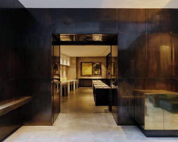 A modern interior with a central hallway leading to a dining area, featuring a long table and chairs. - Straf, Milan, a Member Of Design Hotels (Milan)