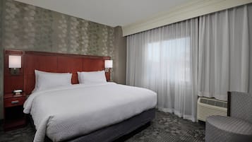 Premium bedding, desk, laptop workspace, blackout drapes