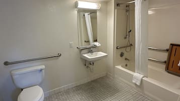 A bathroom with a toilet, sink, shower, and bathtub.