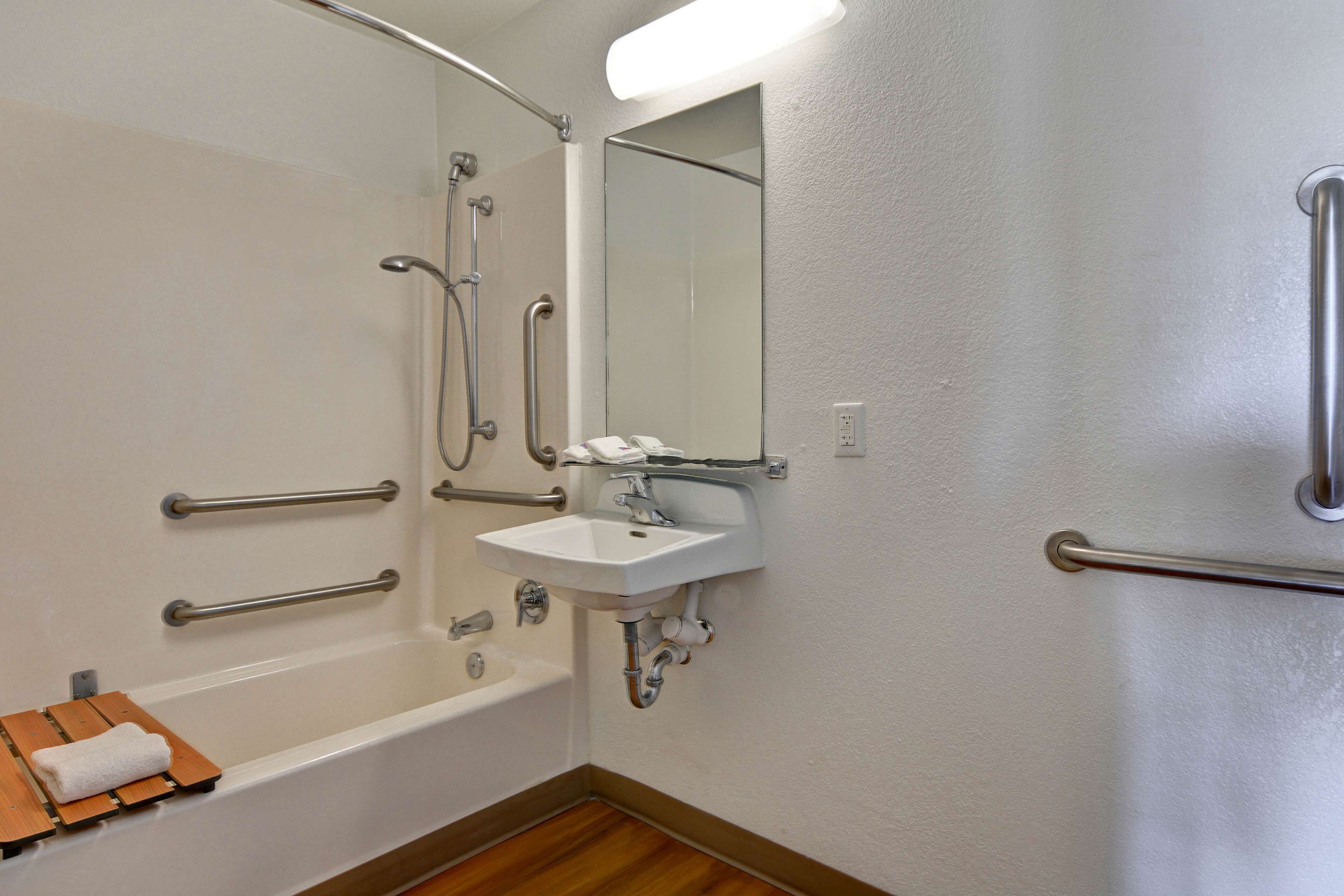 A bathroom with a bathtub, a sink, and a shower.