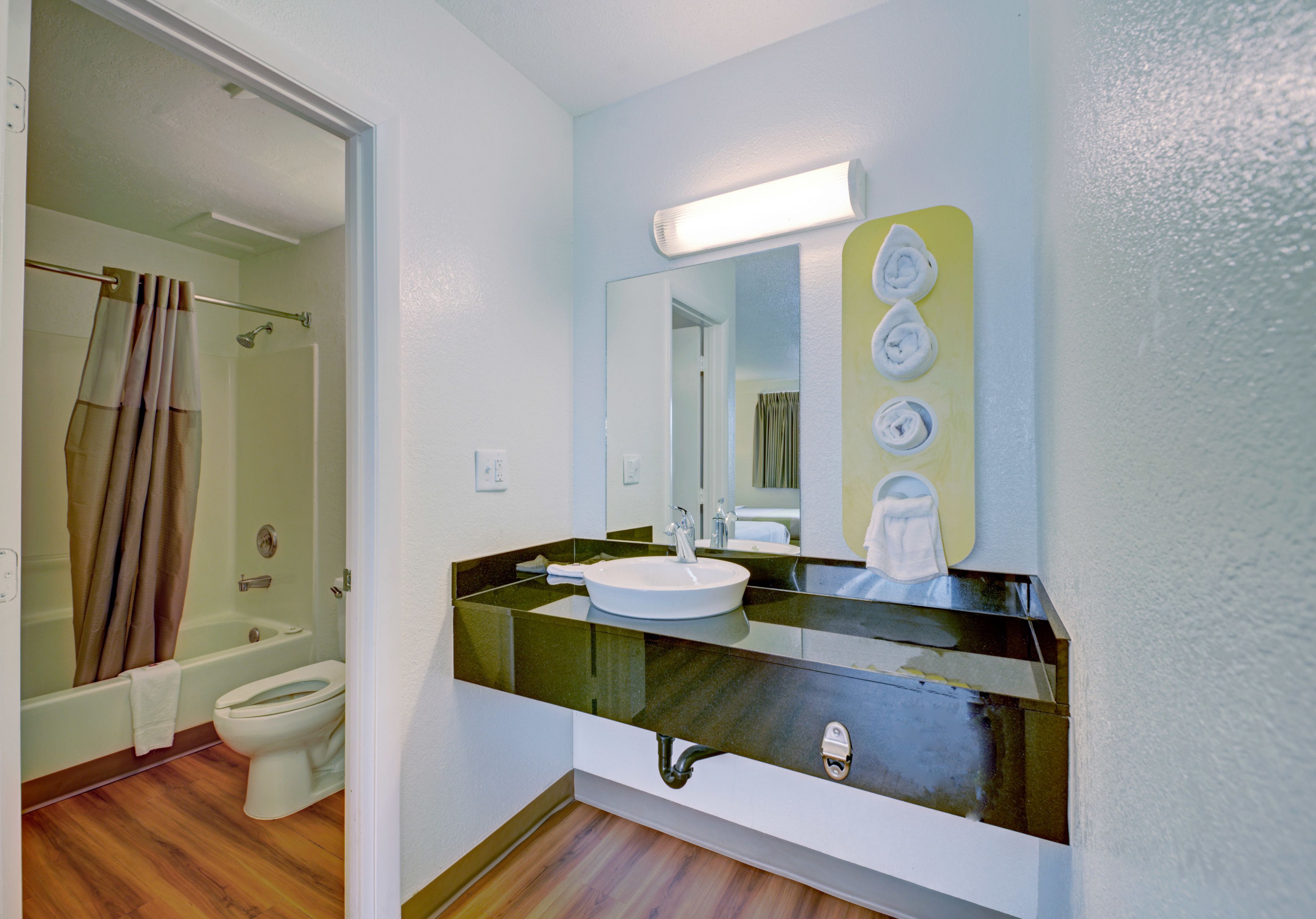 A bathroom with a bathtub, toilet, and sink.