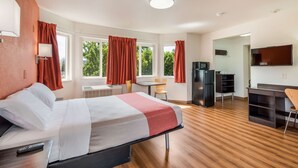A hotel room with a bed, a desk, a chair, a TV, and a refrigerator. - Motel 6 Rohnert Park, CA (Rohnert Park)