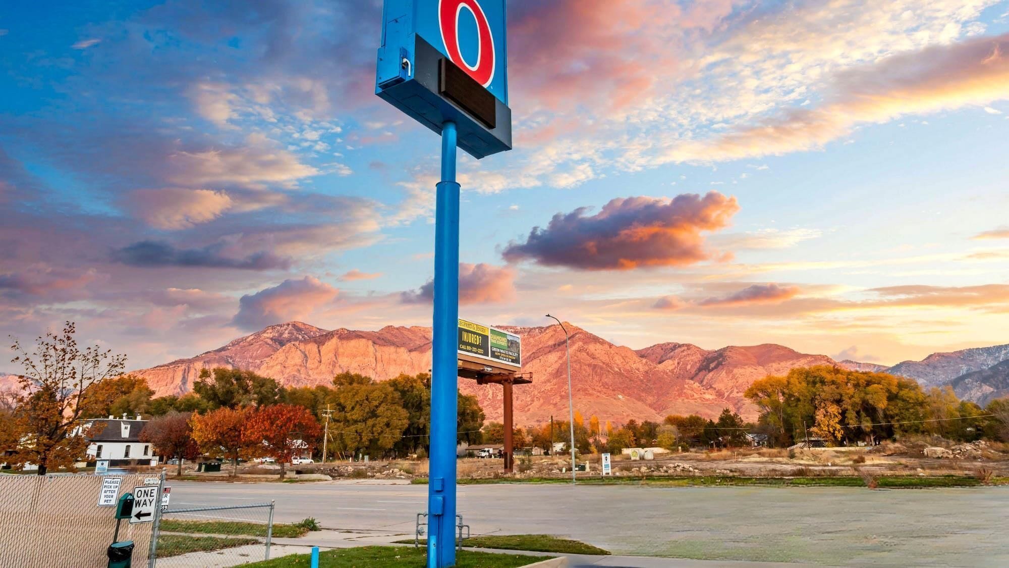 A parking sign with a mountain backdrop.