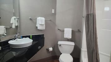A bathroom with a sink, toilet, and towel rack.