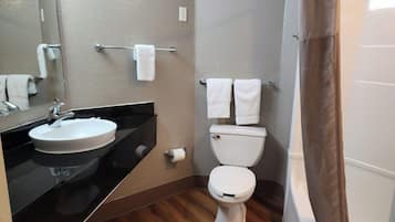 A bathroom with a sink, toilet, and a shower curtain.