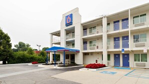 A multi-story motel with a prominent '6' sign, a covered entrance, and a parking area with handicapped accessibility. - Motel 6 Linthicum Heights, MD - BWI Airport (Linthicum Heights)