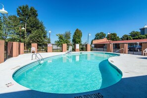 A swimming pool with a no diving sign, surrounded by a fence, and trees in the background. - Econo Lodge Gastonia North (Gastonia)