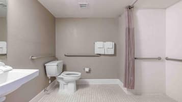 Ein Badezimmer mit Toilette, Waschbecken und Duschbereich.
