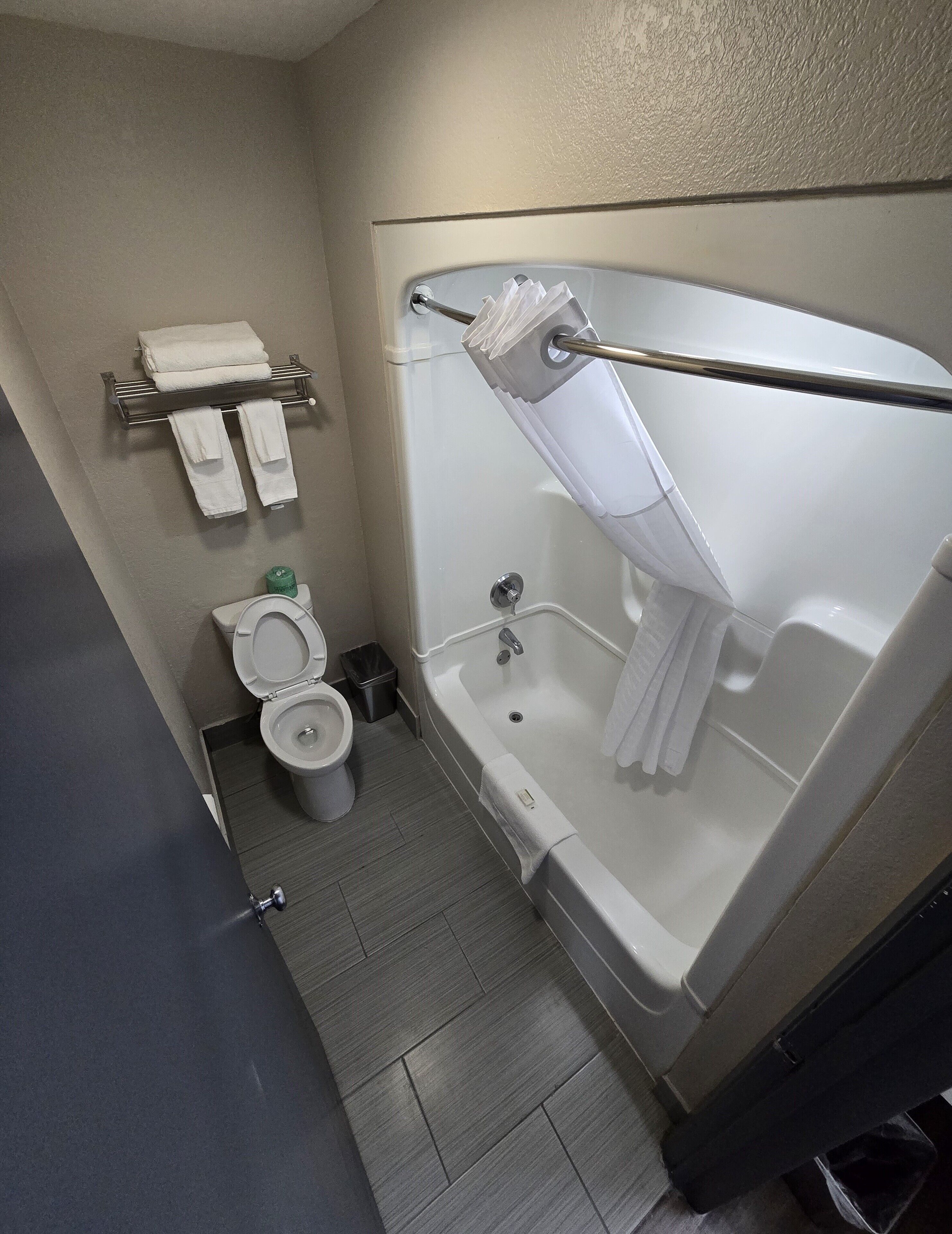 Un baño con inodoro, bañera y zona de ducha.