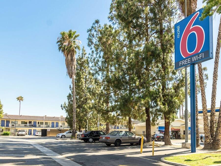 A motel sign with a '6' and 'FREE WI-FI' indicating amenities.